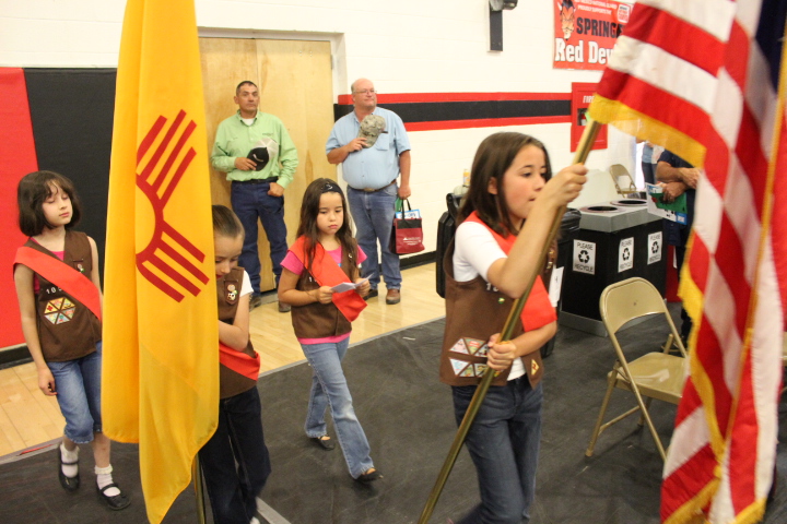 Girl Scouts carry the flags - (l to r) Jordan Romero, Raven Valentine (carrying New Mexico flag), Patricia Trotter, and Brenna Duran carrying U.S flag). Photo by Sherry Goodyear