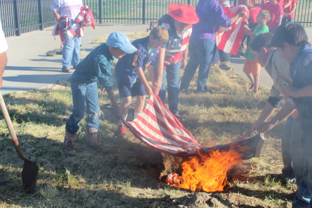 Citizens of various ages all pitch in to make sure that worn U.S. Flags were destroyed in an honorable and respectful way.  Photo by Colette M. Armijo.