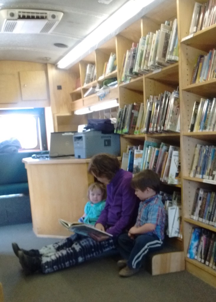 Hendrix and Nina Smith and Grandma Muffin enjoy a snuggle and a book in the Gardner bookmobile. Courtesy photo