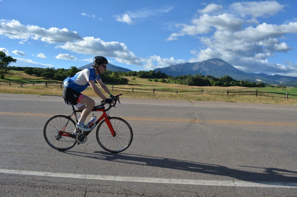 ABOVE: This rider was spotted on Hwy 12 just north of Grandote Peaks Golf Course as he began the Stonewall Century Ride early Saturday morning on August 6. The ride was threatened with bad weather and rain but at least the early morning saw cool temps and gentle clouds over the Spanish Peaks.    Photo by Bob Kennemer.