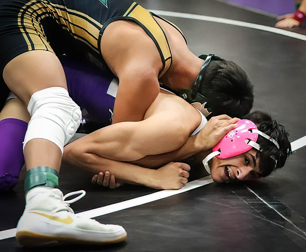 Walsenburg Aiden Trujillo struggles to avoid a pin in his match against Bear Creek’s Jose Fuentes in opening-round action in the 120 lb. Class. Fuentes scored a fall at 3:15 in the match.