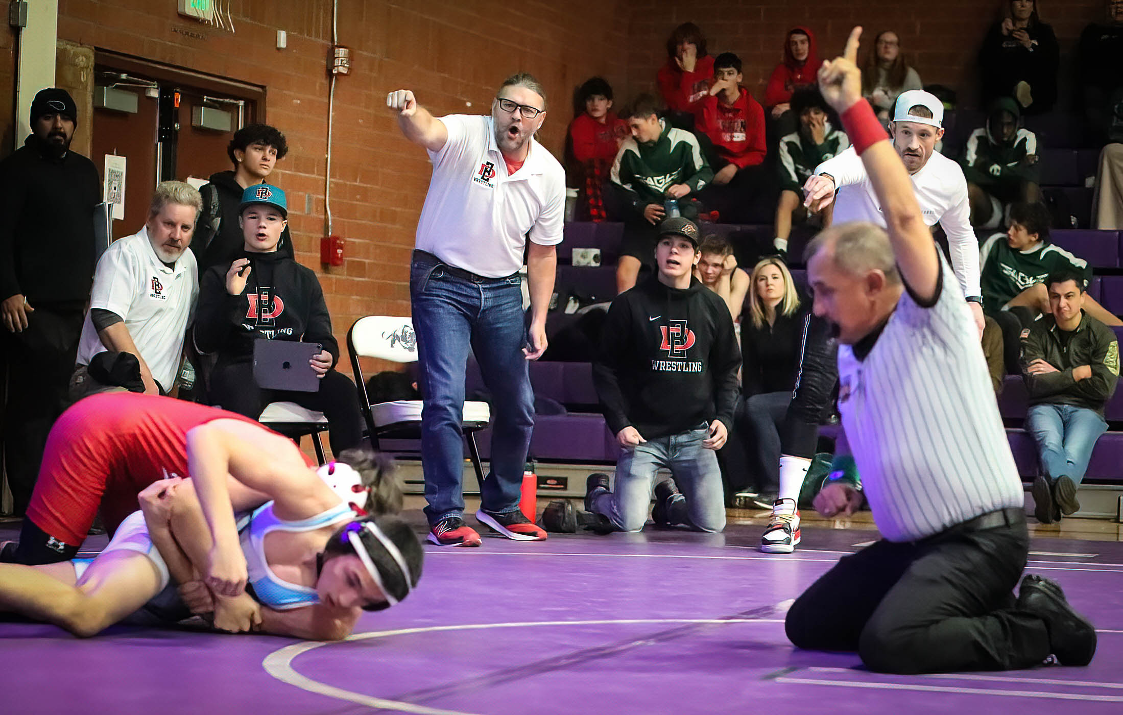 The Dolores coach shouts some strong encouragement to Kenji Edward during his 120 lb. bout against Trinidad’s Damien Ossola. Ossola pinned his opponent at 2:25 in the match.