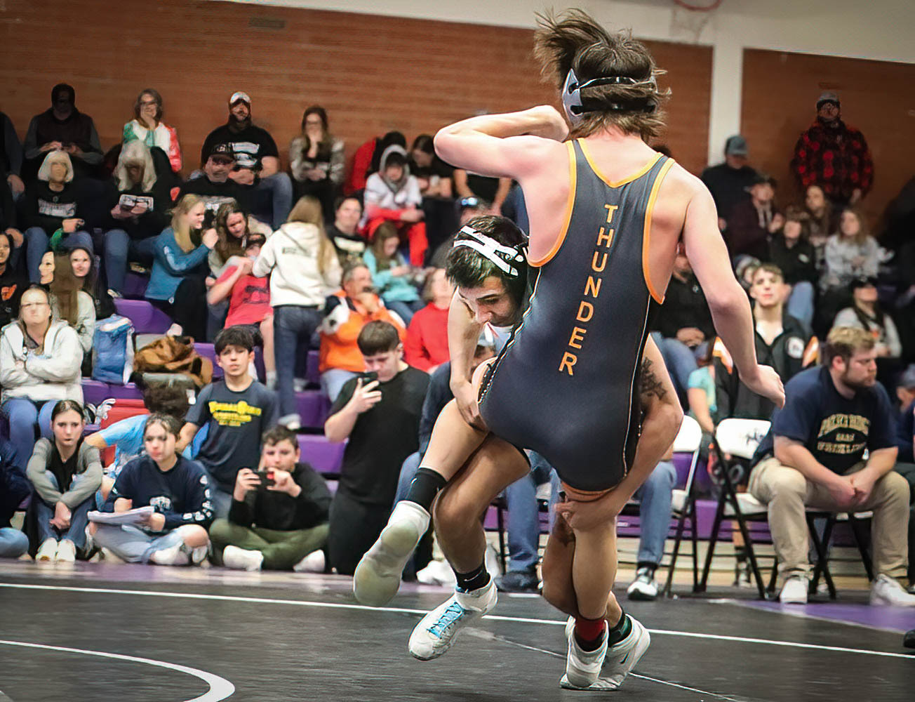 Eddie Bowman delivers his Lamar opponent to the mat in a takedown worthy of the football field.